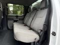 Interior of a 2020 Ford F-550 showing a spacious rear bench seat with grey upholstery and seatbelts