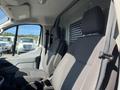 Interior of a 2017 Ford Transit showing front seats with gray upholstery and a dashboard partially visible