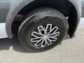 Close-up of a tire on a 2016 Mercedes-Benz Sprinter featuring a shiny alloy wheel and a rugged tread design