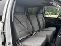 Interior of a 2016 GMC Sierra 1500 showing the back seat with three seats upholstered in gray fabric and seatbelts attached