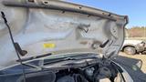 The hood of a 2021 Ford Transit is open revealing the engine compartment with various components visible inside
