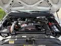 The engine compartment of a 2007 Ford F-450 featuring a Power Stroke V8 turbo diesel engine with various components and cables visible