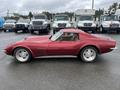 A red 1970 Chevrolet Corvette with a sleek design and distinctive curved body styled with modern multi-spoke wheels