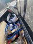 A 2019 Hino 195 truck bed filled with various debris including tangled cables cardboard and scattered trash