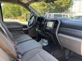 Interior view of a 2019 Ford F-550 showing the driver's side with cloth seats dashboard and center console featuring a touchscreen display