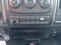 Dashboard controls of a 2013 RAM 5500 featuring buttons for air conditioning towing settings auxiliary inputs and a beacon light