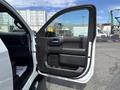 A 2019 Chevrolet Silverado 1500 with its driver's side door open showing the interior door panel and handle