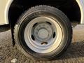 Close-up of a 2010 Ford F-550 wheel featuring a white rim and a Michelin tire with a tread pattern designed for heavy-duty performance