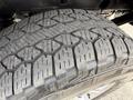 Close-up of a tire tread on a 2018 Chevrolet Silverado 1500 showcasing a rugged design with detailed patterns and grooves