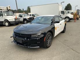 A 2019 Dodge Charger with a black and white exterior featuring a sleek design and sporty contours