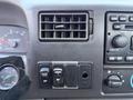 Dashboard of a 2008 Ford F-750 featuring air vents control knobs and buttons for cruise control and settings