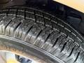 Close-up of a Michelin tire showing detailed tread patterns and grooves on a 2015 GMC Savana