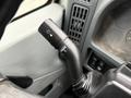 Close-up of a turn signal lever on a 2006 International 4200 with marked positions for various functions including turn signals and windshield wipers