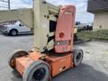A 2009 JLG E300AJP aerial work platform with orange and cream-colored components and large rubber wheels