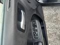 Interior door panel of a 2015 Dodge Charger featuring a chrome door handle and a control panel with window and mirror adjustment buttons