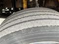 A close-up of a worn-out tire from a 2007 Freightliner B2 showing visible tread wear and dirt on the surface