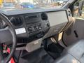 The interior dashboard of a 2009 Ford F-450 Super Duty featuring controls for audio climate and vents with a seat visible on the right