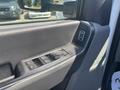 Close-up of the interior door panel of a 2023 Ford F-350 SD featuring controls for windows and mirrors