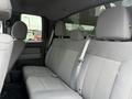 Interior of a 2014 Ford F-150 showing the rear seating area with gray fabric upholstery and three seats with headrests