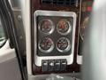 Interior dashboard of a 2018 Kenworth T800 featuring gauges for DEF level, pressure, voltage, and water temperature along with control buttons for various functions