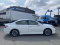 A white 2017 Honda Accord Hybrid parked with a side view showing its sleek design and alloy wheels