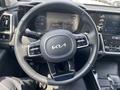 2022 Kia Sorento steering wheel with control buttons and dashboard display in the background