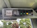 Control panel of a 2014 Wacker Neuson WL34 featuring various switches and a digital display with indicator lights