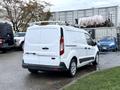 A 2017 Ford Transit Connect van in white with a roof rack and rear sliding doors parked on a surface
