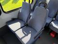 Two blue fabric seats with armrests and seatbelts inside a Chevrolet Express van