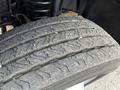 A close-up view of a worn tire from a 2008 Ford F-450 showing uneven tread wear and visible grooves