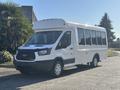 A 2017 Ford Transit-350 bus with a white exterior and large windows designed for passenger transport