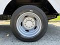 Close-up of a 2008 Ford F-550 wheel showcasing a silver rim with multiple lug nuts and a black tire