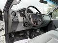 Interior view of a 2015 Ford F-350 SD showing the steering wheel dashboard and console with controls and gauges