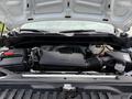 The engine compartment of a 2019 Chevrolet Silverado 1500 showcasing the engine and various components including the battery and air intake system