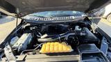 View of the engine compartment of a 2016 Ford F-150 showing the engine block air intake and various engine components