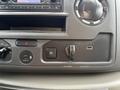 A close-up of the dashboard control panel in a 2024 Ford E-450 featuring various buttons including a USB port and a toggle switch