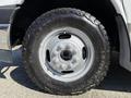 Close-up of a 2017 Chevrolet Express tire showing the rugged tread design and a silver steel wheel with a central rim bolt pattern