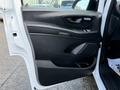 The interior door panel of a 2020 Mercedes-Benz Metris featuring a black design with controls for windows and door locks