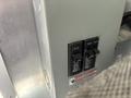 A close-up view of three circuit breakers in an electrical panel with labeled switches in the off position