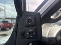 Control panel for adjusting side mirrors in a 2018 Chevrolet Express featuring directional buttons for left and right adjustments
