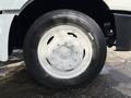 Close-up of a white wheel mounted on a 2014 International TerraStar showing a steel rim and a black tire with visible tread patterns