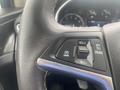 Close-up of the steering wheel controls of a 2018 Buick Encore featuring cruise control, a cancel button, and a toggle switch for adjustments