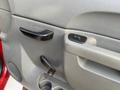 Interior door panel of a 2013 Chevrolet Silverado 3500HD featuring a black door handle and window control buttons