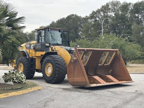 A 2012 Caterpillar 980 wheel loader with a large bucket in front, featuring yellow and black coloring and a sturdy build