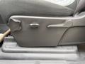 The seat adjustment controls for a 2013 Chevrolet Silverado 3500HD featuring a knob and lever for seat positioning and height adjustment
