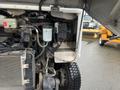 Close-up of the engine compartment of a 2012 Workhorse W62 showing various components including hoses a filter and wiring