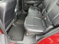 Interior view of the backseat of a 2016 Mitsubishi Outlander featuring black leather upholstery and three seats with seat belts