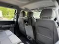 Interior view of the back seat area of a 2021 Ford F-150 featuring two rows of seats with seatbelts and a central armrest