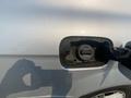 A close-up of the fuel cap on a 2013 Mercedes-Benz C-Class with the cap open revealing the fuel filler neck
