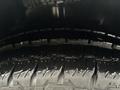 A close-up of a tire showing the tread pattern and water droplets on the surface of a 2021 Mercedes-Benz Metris